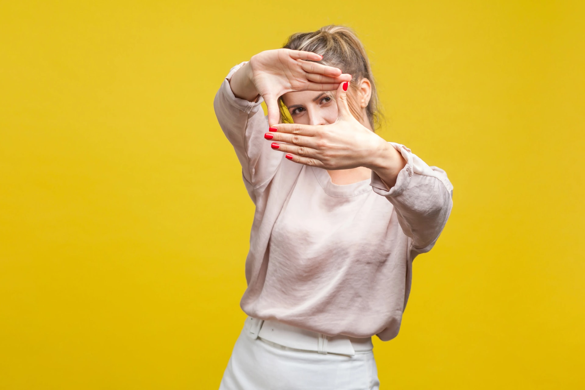 femme-créant-un-cadran-avec-ses-mains-laissant-apparaître-un-œil-illustrant-la-concentration 